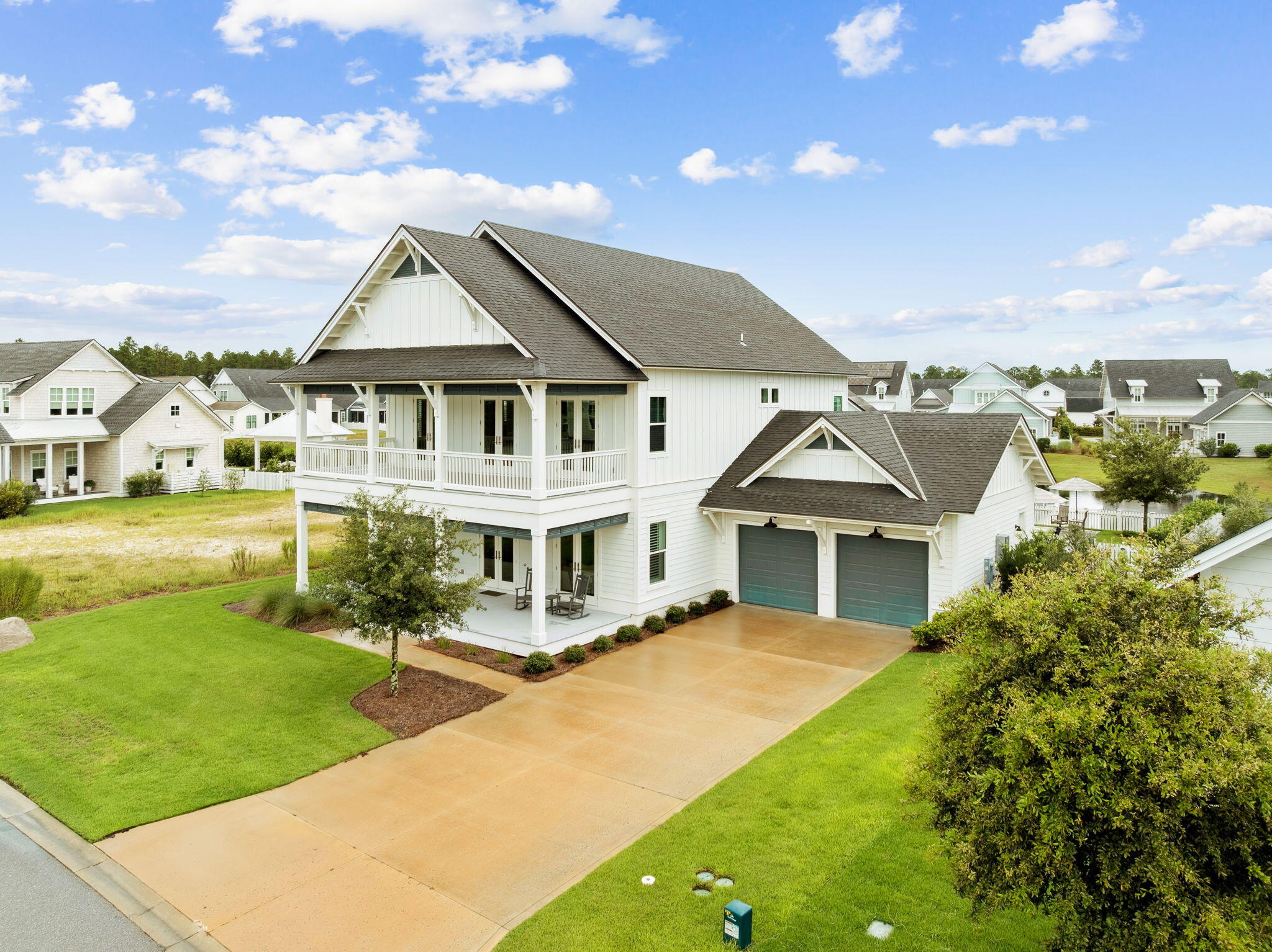 121 Needle Cast Ln Inlet Beach Inlet Beach, FL 32461 - Photo 12 of 63 a view of a white house with a big yard and potted plants