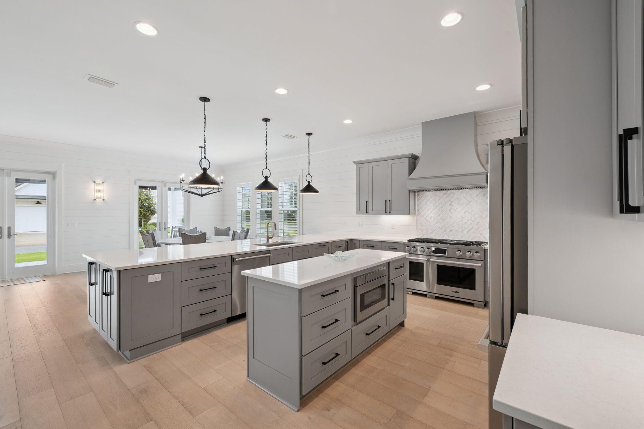 121 Needle Cast Ln Inlet Beach Inlet Beach, FL 32461 - Photo 22 of 63 a kitchen with stainless steel appliances granite countertop a stove a sink a refrigerator and white cabinets