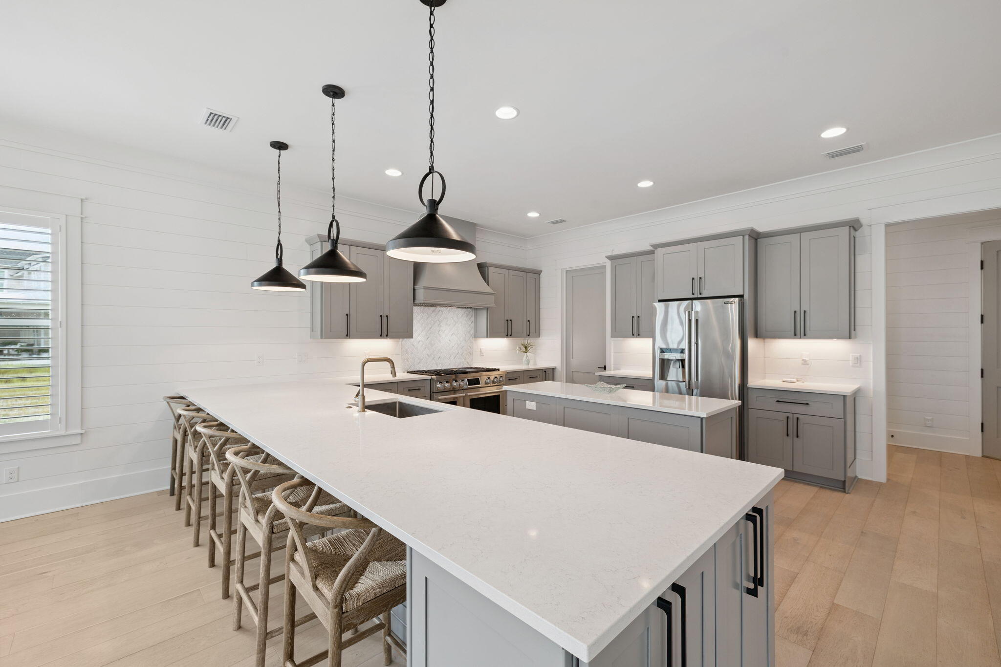 121 Needle Cast Ln Inlet Beach Inlet Beach, FL 32461 - Photo 23 of 63 a kitchen with a stove a sink a refrigerator and chairs