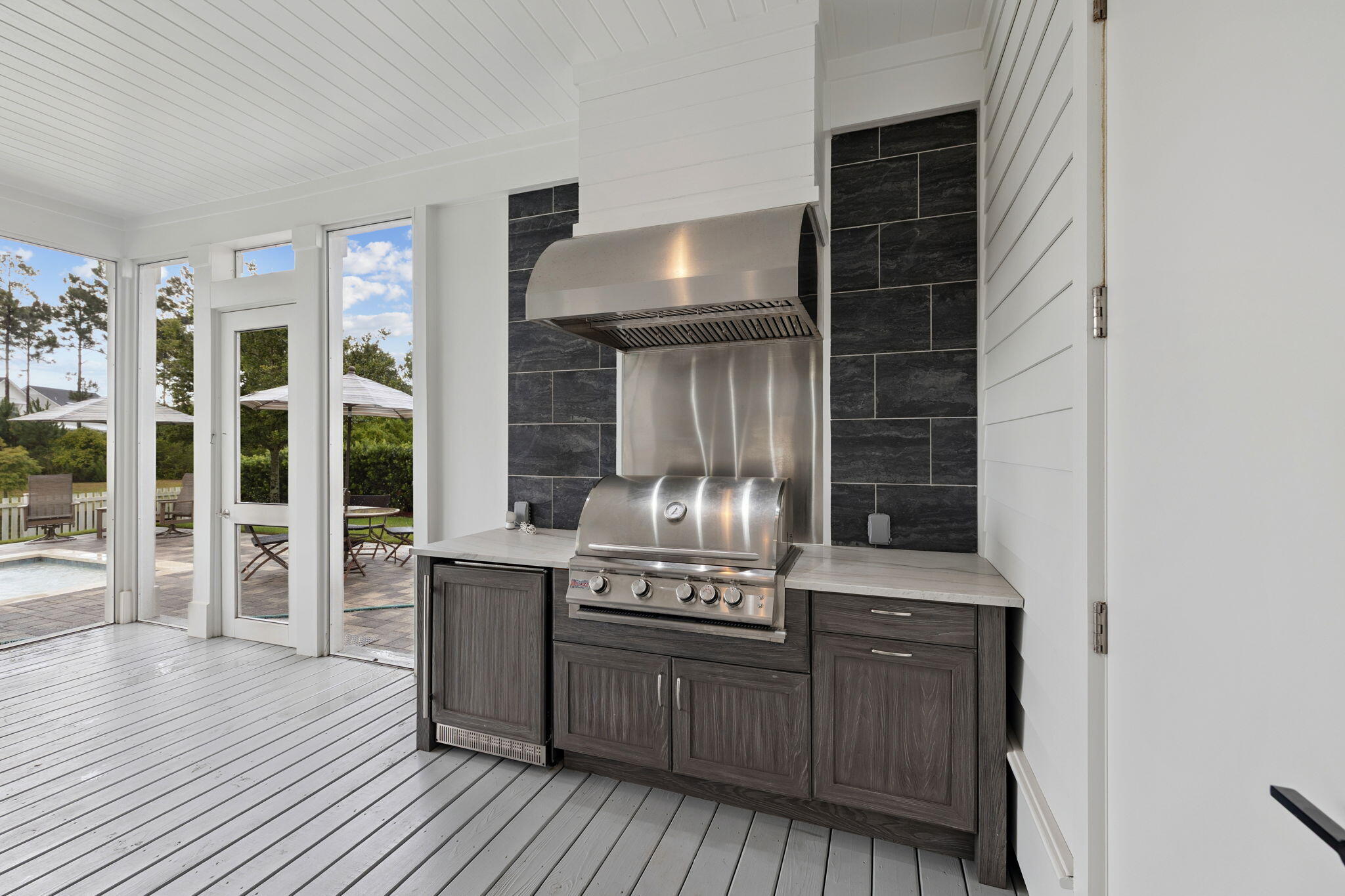 121 Needle Cast Ln Inlet Beach Inlet Beach, FL 32461 - Photo 57 of 63 a kitchen with stainless steel appliances granite countertop a stove and a wooden cabinets