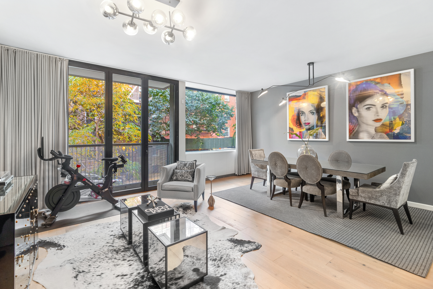 277 East 7th Street, Unit 2 Manhattan, NY 10009 - Photo 1 of 11 a living room with furniture a dining table and a large window