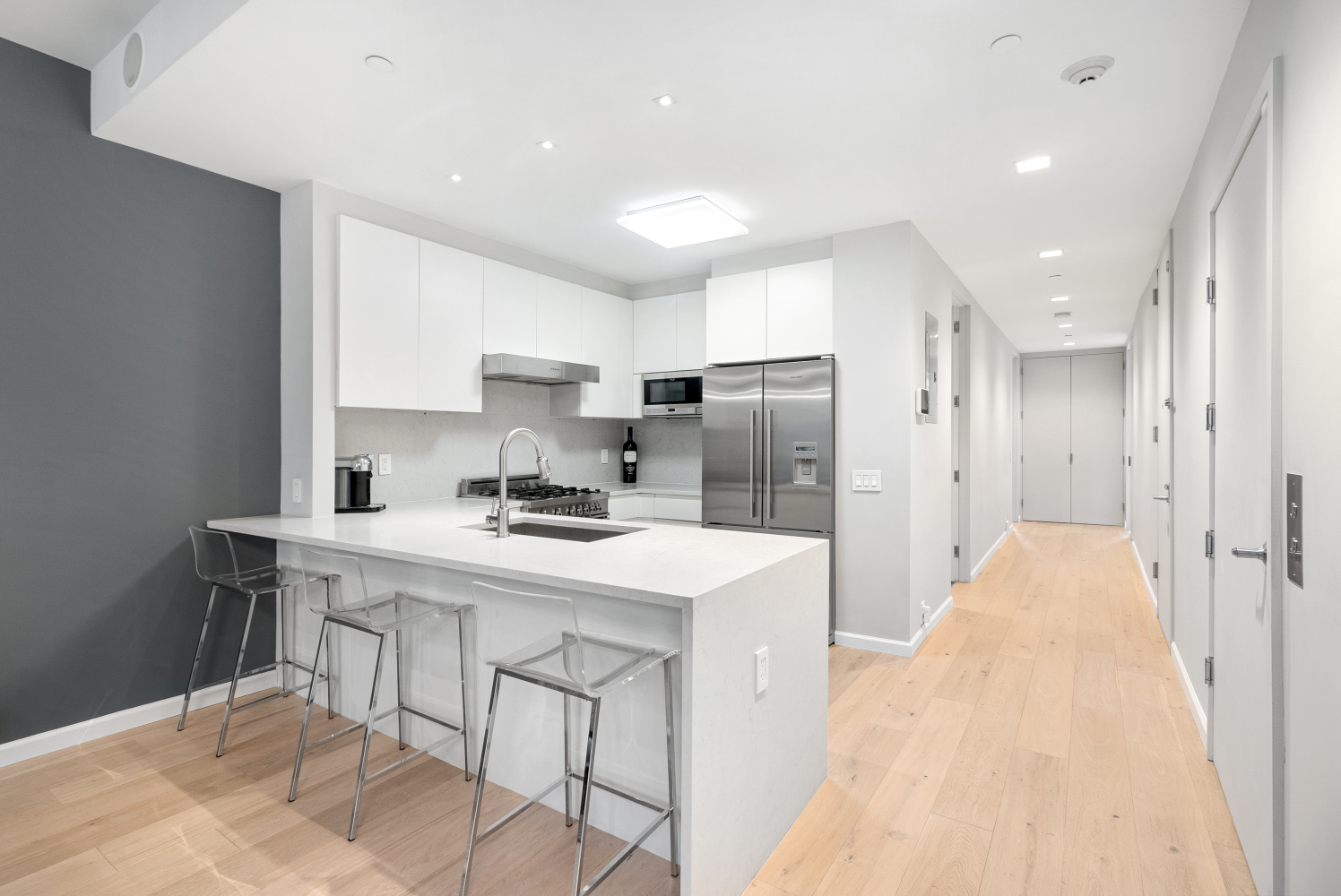 277 East 7th Street, Unit 2 Manhattan, NY 10009 - Photo 4 of 11 a kitchen with stainless steel appliances a sink a stove a refrigerator and cabinets