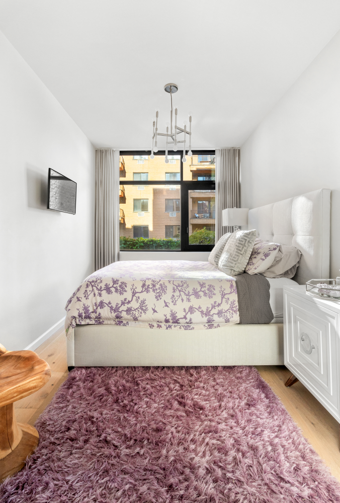 277 East 7th Street, Unit 2 Manhattan, NY 10009 - Photo 6 of 11 a living room with hard wood flooring and a couch