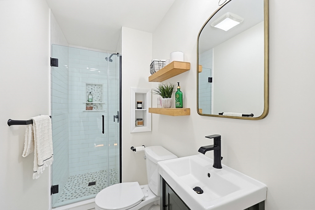 345 Sherman Street Canton, MA 02021 - Photo 17 of 42 a bathroom with a sink and a mirror