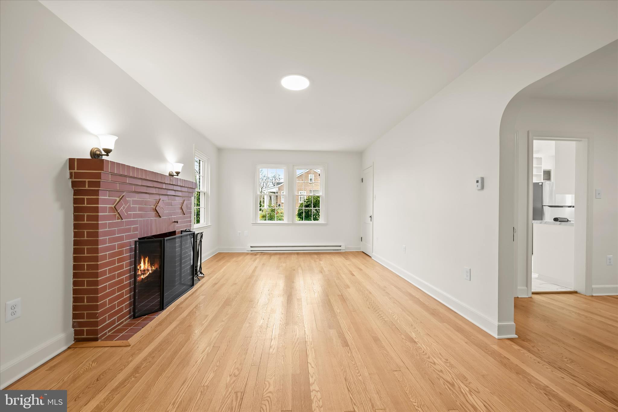1631 Shookstown Road Frederick, MD 21702 - Photo 12 of 69 an empty room with wooden floor fireplace and windows