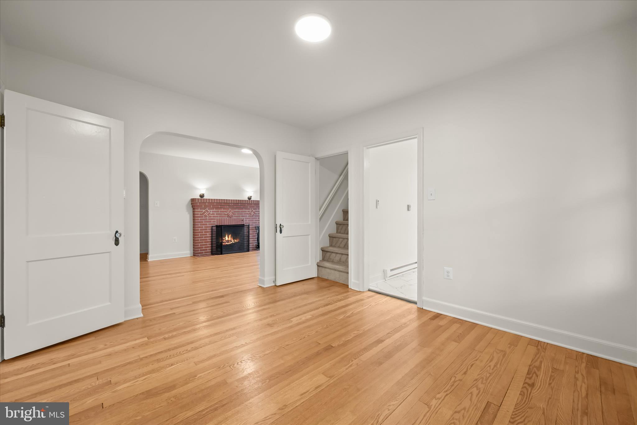 1631 Shookstown Road Frederick, MD 21702 - Photo 13 of 69 an empty room with wooden floor and a fireplace