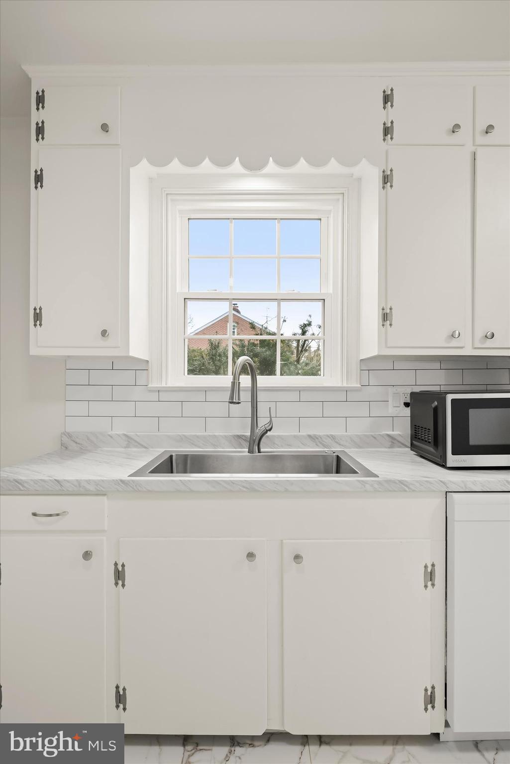 1631 Shookstown Road Frederick, MD 21702 - Photo 21 of 69 a kitchen with stainless steel appliances granite countertop a sink a stove and white cabinets