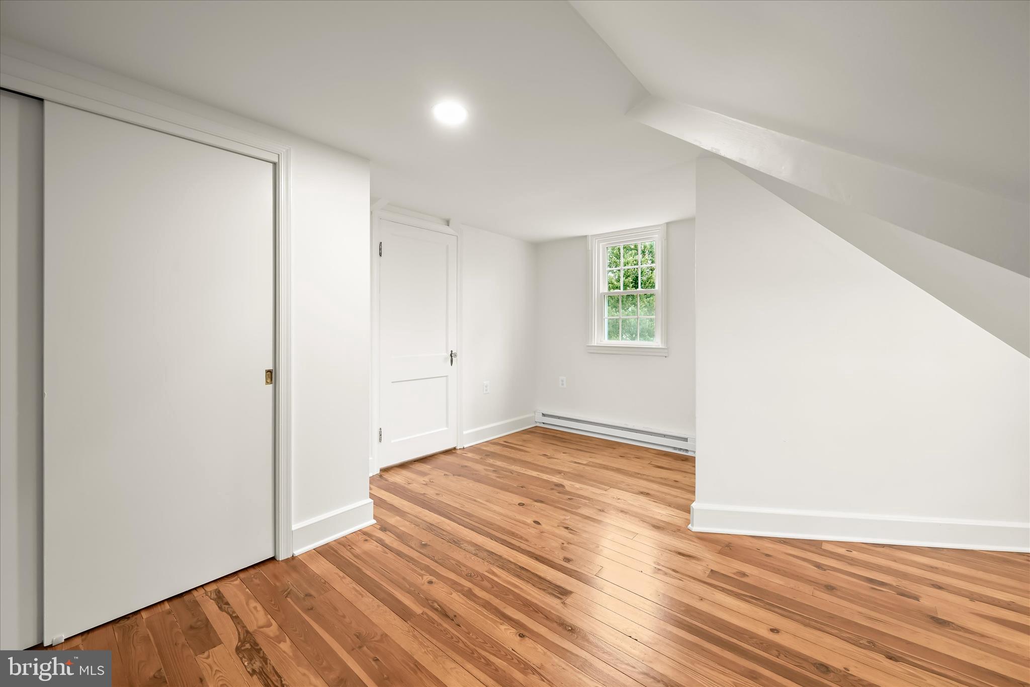 1631 Shookstown Road Frederick, MD 21702 - Photo 39 of 69 a view of an empty room with wooden floor and a window