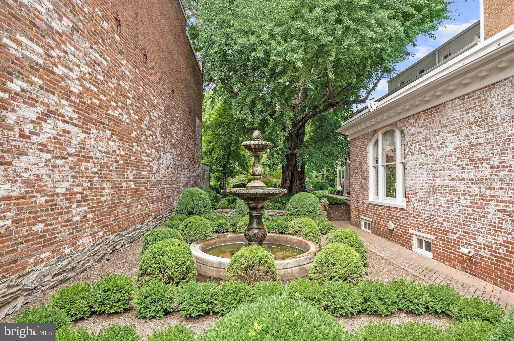 1631 Shookstown Road Frederick, MD 21702 - Photo 67 of 69 a view of a garden with plants and a bench