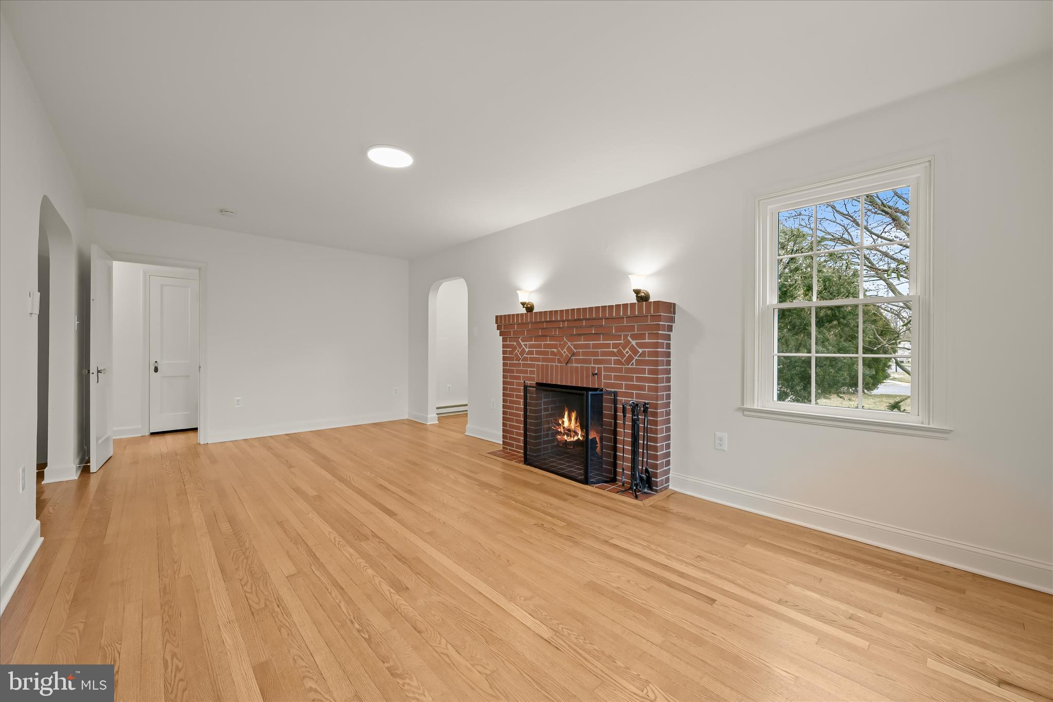 1631 Shookstown Road Frederick, MD 21702 - Photo 10 of 69 a view of empty room with wooden floor and fireplace