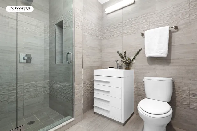 a bathroom with a toilet and a shower