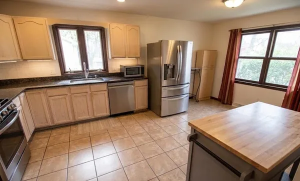 a kitchen with stainless steel appliances a refrigerator and a sink