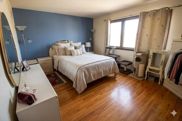 a bedroom with a bed and wooden floor