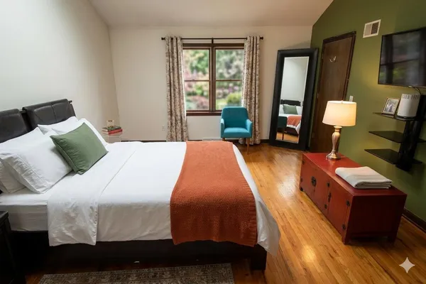 a bed sitting in a bedroom next to a window