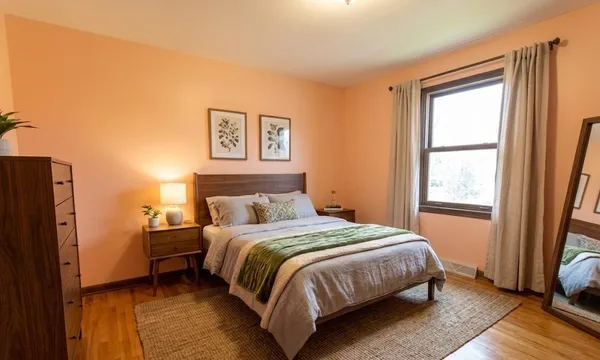 a bedroom with a bed and a window