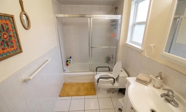 a bathroom with a sink a toilet and shower