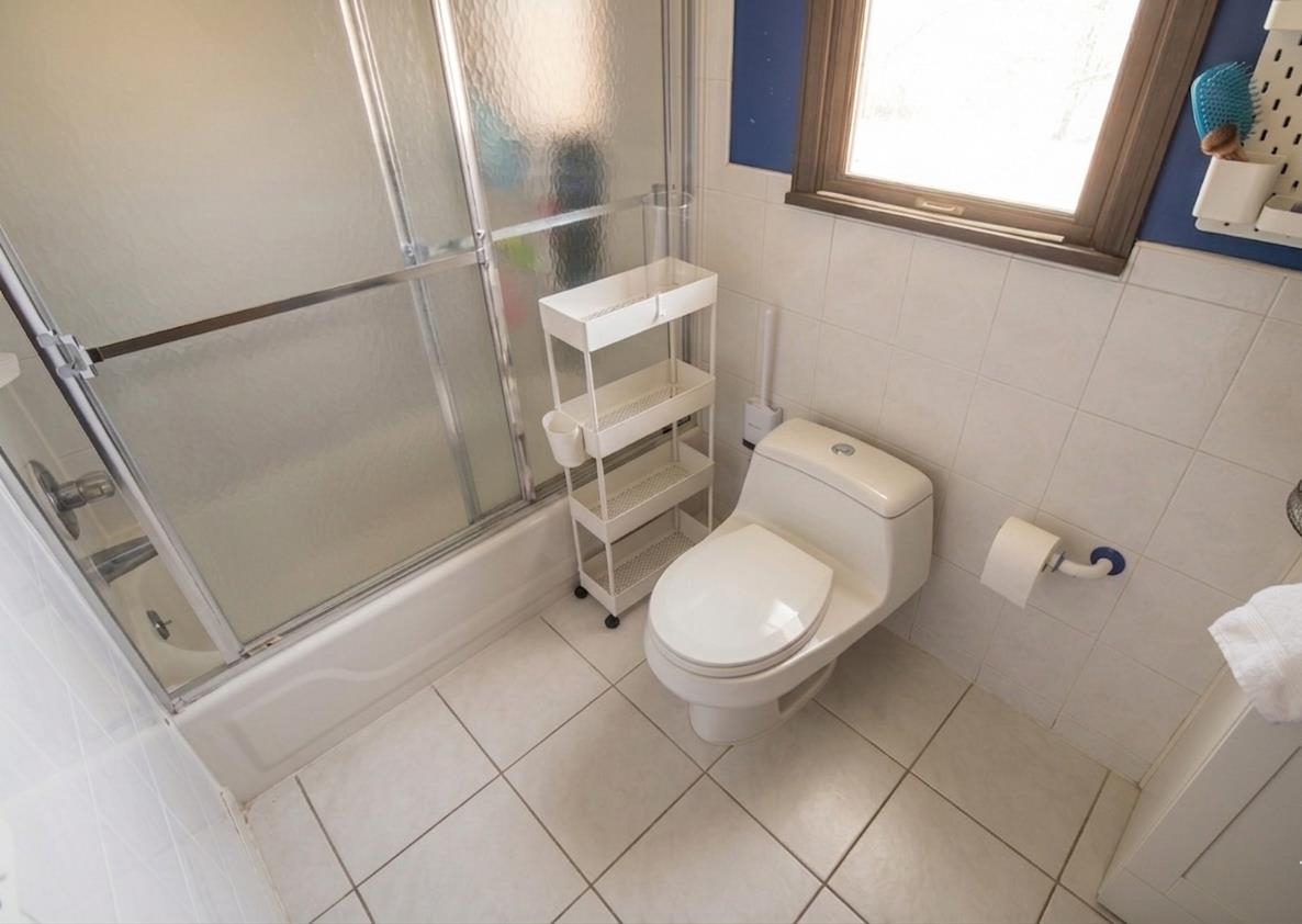 730 Humboldt Street, Unit 2 Secaucus, NJ 07094 - Photo 10 of 28 a white toilet sitting next to a bathroom sink and a shower
