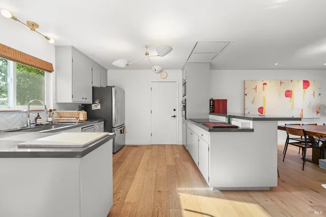 a kitchen with cabinets a sink and appliances