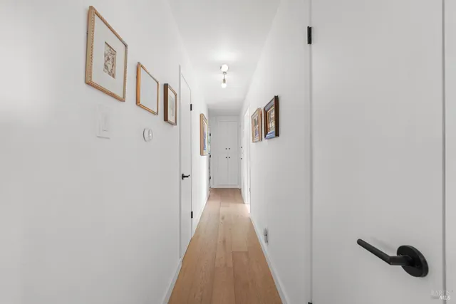 a view of a hallway with wooden floor
