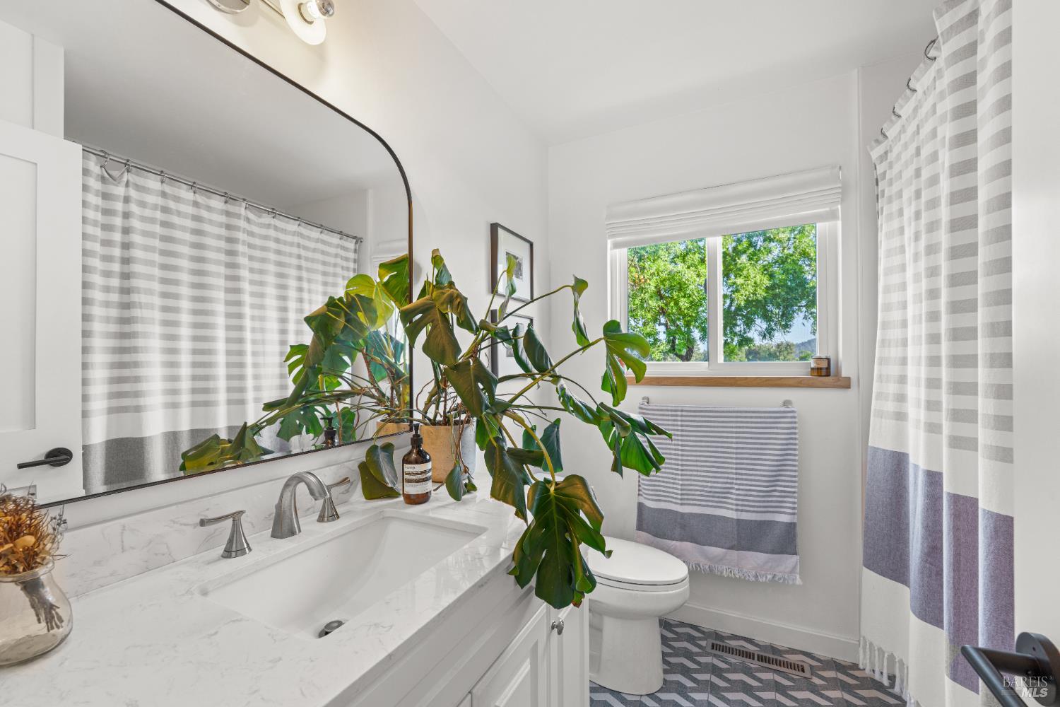 21800 River Road Geyserville, CA 95441 - Photo 20 of 30 a bathroom with a granite countertop sink a toilet and a mirror