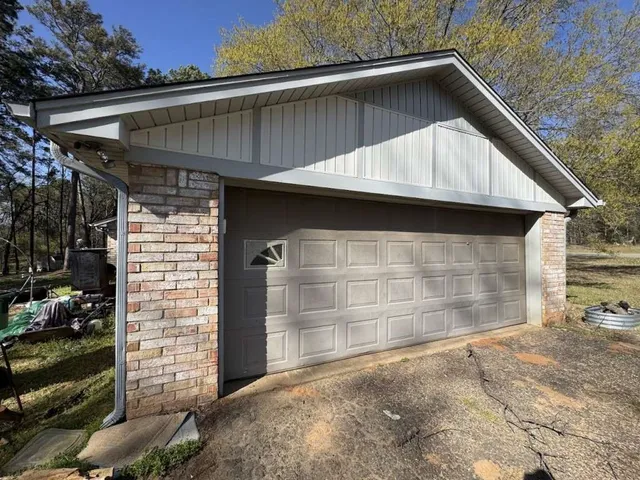 a side view of a house with a garage