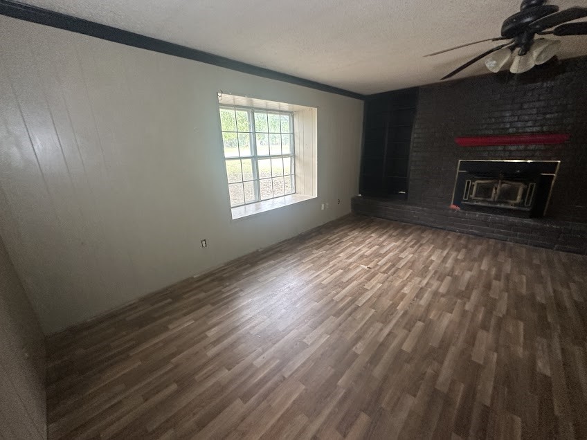 447 Plum Creek Road Longview, TX 75605 - Photo 3 of 11 a view of empty room with wooden floor and fireplace