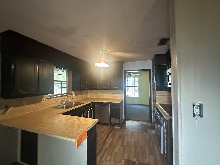 447 Plum Creek Road Longview, TX 75605 - Photo 5 of 11 a kitchen with a sink stove and refrigerator