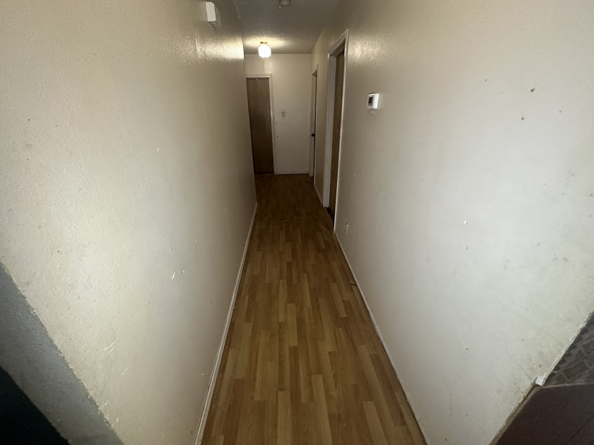 447 Plum Creek Road Longview, TX 75605 - Photo 6 of 11 a view of a hallway with wooden floor