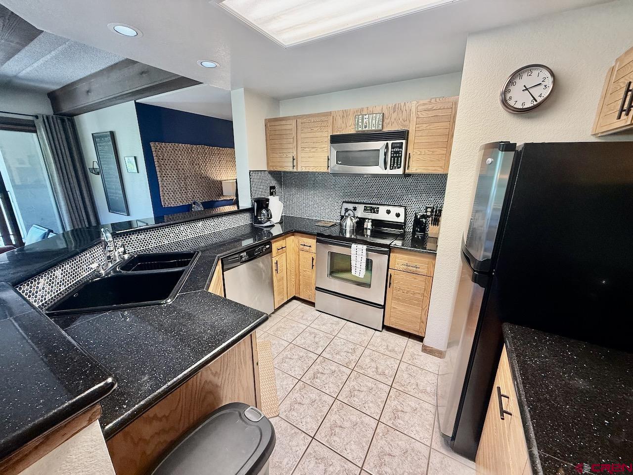 11 Snowmass Road, Unit 337 Crested Butte, CO 81225 - Photo 9 of 35 a kitchen with stainless steel appliances granite countertop a sink stove and refrigerator