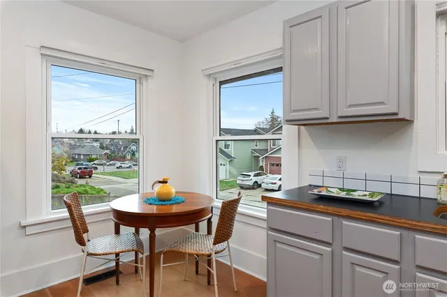 a kitchen with a table chairs and cabinets