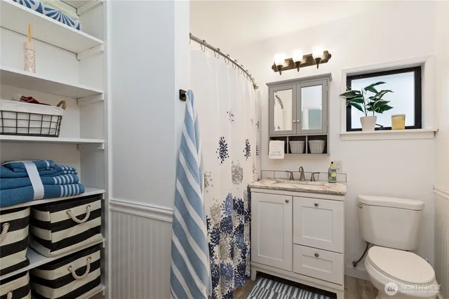 a bathroom with a toilet a sink and a mirror