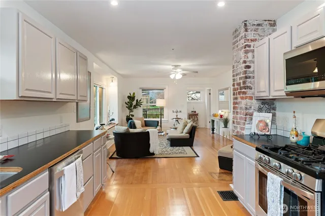 a kitchen with sink stove and microwave