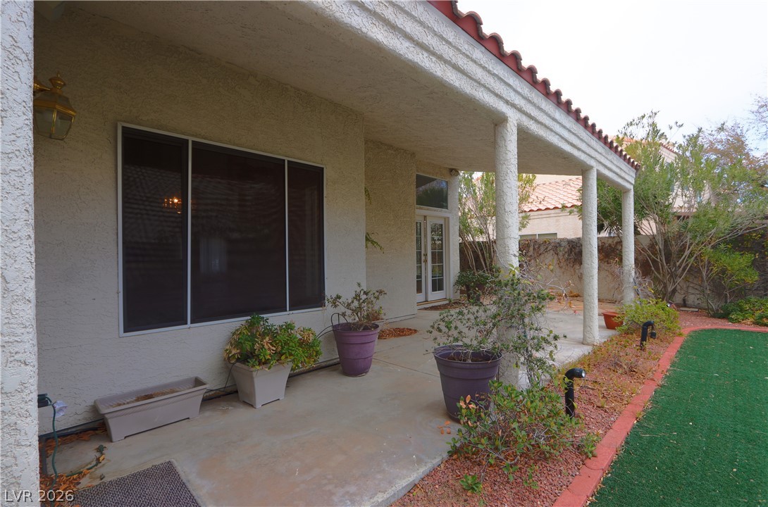 2108 Crestpoint Way Las Vegas, NV 89134 - Photo 23 of 27 A private backyard patio with columns offers an ideal space for outdoor relaxation and entertaining.
