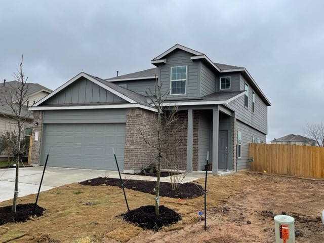 10413 Premier Park Street Austin, TX 78747 - Photo 1 of 24 a front view of a house with parking