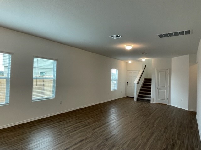10413 Premier Park Street Austin, TX 78747 - Photo 11 of 24 an empty room with wooden floor and windows