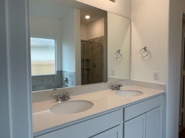 10413 Premier Park Street Austin, TX 78747 - Photo 12 of 24 a bathroom with a sink and a mirror