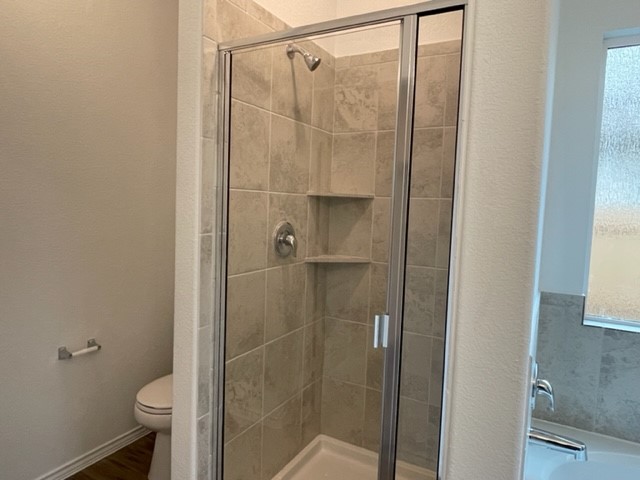 10413 Premier Park Street Austin, TX 78747 - Photo 14 of 24 a bathroom with a shower and a toilet
