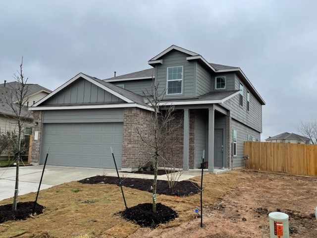10413 Premier Park Street Austin, TX 78747 - Photo 2 of 24 a front view of a house with parking