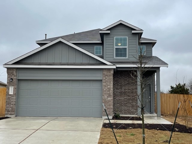 10413 Premier Park Street Austin, TX 78747 - Photo 3 of 24 a front view of a house with garage