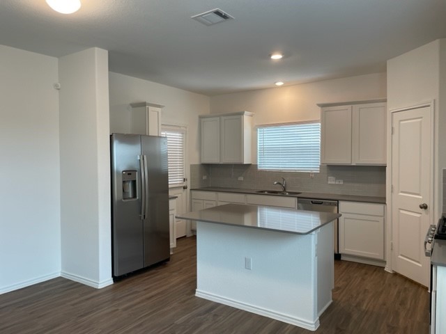 10413 Premier Park Street Austin, TX 78747 - Photo 6 of 24 a kitchen with stainless steel appliances granite countertop a refrigerator and a sink
