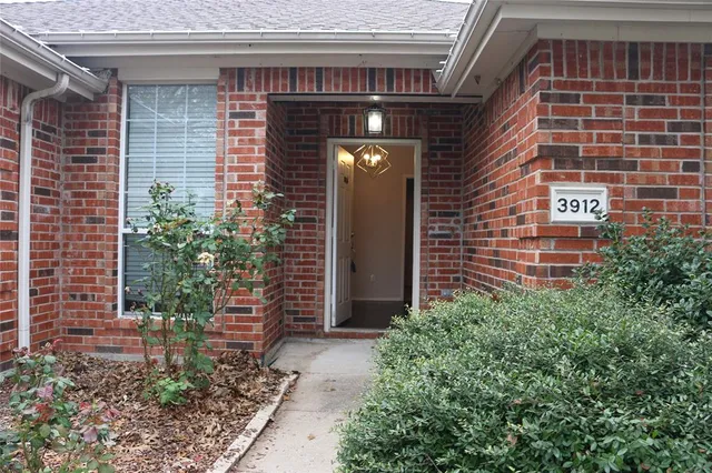 a front view of a house with plants
