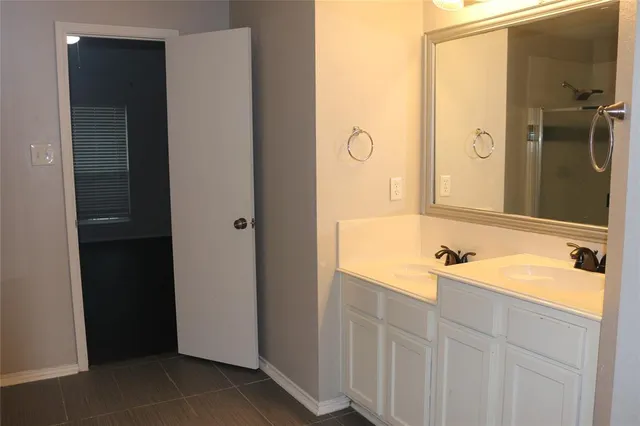 a bathroom with a bathtub next to a window