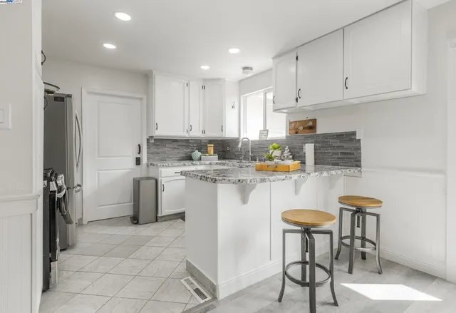 a kitchen with a sink cabinets and stainless steel appliances