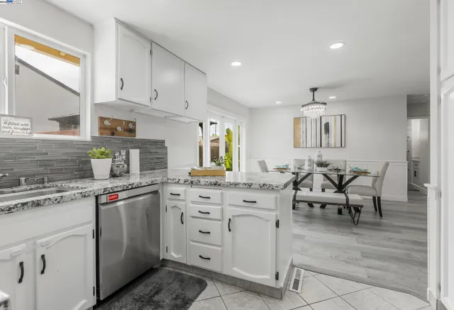 a kitchen with cabinets appliances and a counter