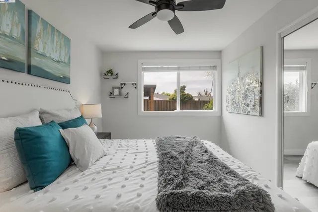 a bedroom with a large bed and a window