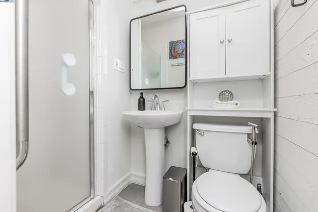 a bathroom with a toilet sink and mirror