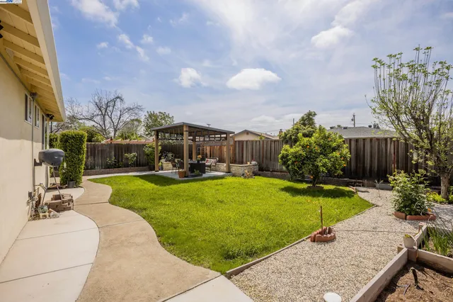 a view of a house with swimming pool and sitting area