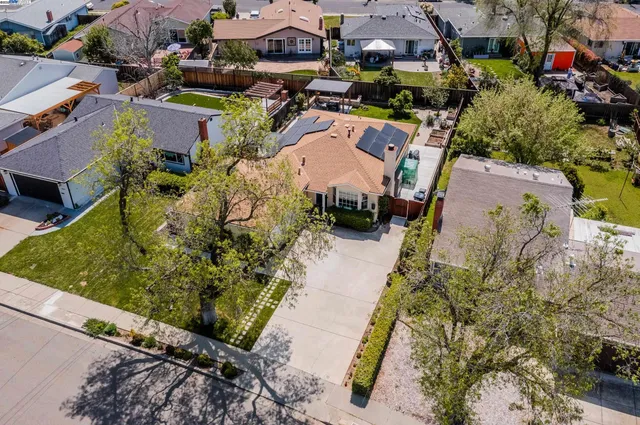 an aerial view of a house with a yard and lake view