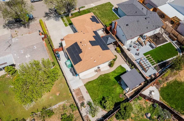 an aerial view of a house with a garden and swimming pool