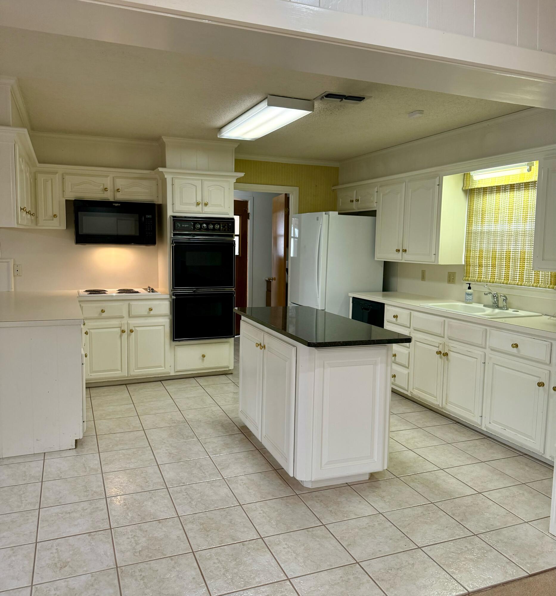 3012 69th Street Lubbock, TX 79413 - Photo 16 of 38 a kitchen with stainless steel appliances a refrigerator sink and microwave